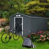 A garden shed with two bicycles and a lawnmower in a garden setting. Produktbild-Vorschau