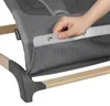 A close-up of a baby bouncer with a hand adjusting a strap. Produktbild-Vorschau