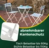 A white metal bistro set with two chairs and a table, set up on a wooden deck with some greenery in the background. There are also text overlays highlighting features and specifications. Náhled obrázku produktu