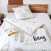 A bedding set with a sloth design is laid out on a bed. Produktbild-Vorschau