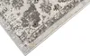 A close-up view of a rug with a distressed pattern. Voir les images du produit