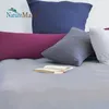 A collection of pillows and a book on a bed. Produktbild-Vorschau