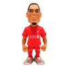 A figurine of a soccer player in a red jersey. Anteprima dell’immagine prodotto