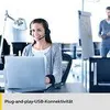 A woman wearing a headset is working on a laptop in an office environment. Anteprima dell’immagine prodotto