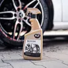 A bottle of K2 Roton wheel cleaner is placed in front of a car wheel. Náhled obrázku produktu