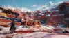 A snowy, mountainous landscape with red rock formations and some wooden structures. Náhľad obrázku produktu
