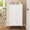 A white shoe cabinet with gold legs is shown in a room with a rug and a window. Anteprima dell’immagine prodotto