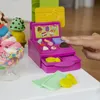 A close-up shot of a Play-Doh ice cream shop playset with a hand interacting with it. Produktbild-Vorschau