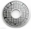 A close-up, top-down view of a silver and black collectible coin or disc with intricate text and patterns. Náhľad obrázku produktu