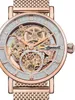 Close-up of a skeletonized watch face with rose gold accents and a mesh strap. Náhled obrázku produktu