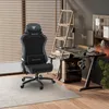 A gaming setup with a chair, desk, computer, and monitor in a room. Produktbild-Vorschau