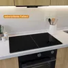 A modern kitchen countertop with a black glass induction hob and an oven below, with wooden cabinets above. Produktbild-Vorschau