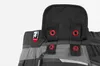 A close-up view of the upper part of a work garment, showing attachment points and a logo. Produktbild-Vorschau