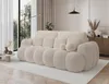 A modern living room with a large, cream-colored sofa as the focal point. Produktbild-Vorschau