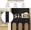 A black cabinet with a built-in charging station, featuring a small oven and various kitchen items on top. The charging station is highlighted in a circular inset. Podgląd zdjęcia produktu