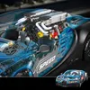 A detailed view of a model car engine and a smaller inset image of the complete model car. Voir les images du produit
