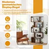 A modern geometric display shelf filled with books, decorative items, and photos, placed next to a leather armchair in a living room setting. Anteprima dell’immagine prodotto