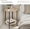A round side table with two shelves next to a bed. Náhled obrázku produktu