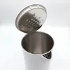 A close-up, top-down view of a white electric kettle with its stainless steel lid open, revealing the interior. Podgląd zdjęcia produktu