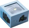 A light blue box with a clear window showing a black paw-shaped GPS tracker inside. The box has images of the product and text indicating color options. Produktbild-Vorschau