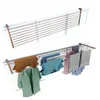 Two wall-mounted drying racks, one empty and one with clothes. Voir les images du produit