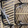 Close-up view of the underside of a rattan chair, showing the metal frame and tie straps. Produktbild-Vorschau