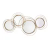 A decorative wall mirror set with four circular mirrors of varying sizes, interconnected by thin, gold-colored wire frames. Produktbild-Vorschau