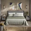 A bedroom scene featuring a bed with nightstands and artwork. Voir les images du produit