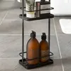 A black metal bathroom caddy with three shelves, holding various bottles and tubes of toiletries. Podgląd zdjęcia produktu