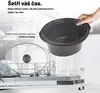 A hand holding a slow cooker insert over a dishwasher with dishes inside. Náhled obrázku produktu