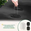 A hand is holding a metal stake over black landscape fabric with two black plastic anchors on it. A small plant is in the upper left corner. A text box in the lower left corner describes the product. Produktbild-Vorschau