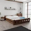 A bedroom scene with a wooden bed frame and nightstand. Náhled obrázku produktu