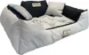 A dog bed with raised sides and multiple pillows. Náhled obrázku produktu
