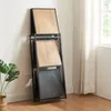 A folded shelf unit leans against a wall next to a window with sheer curtains. Náhled obrázku produktu