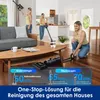 Three women are using a cordless vacuum cleaner in a modern living room and kitchen area. Podgląd zdjęcia produktu
