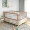 A toddler bed guardrail is installed on a bed in a bedroom setting. Voir les images du produit