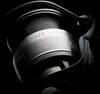 A close-up, dramatic shot of a fishing reel. Náhled obrázku produktu