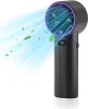A black portable fan with a purple accent, blowing blue air with green leaves. Náhled obrázku produktu