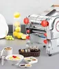 A stainless steel noodle maker is displayed on a countertop, surrounded by ingredients and serving dishes. Produktbild-Vorschau