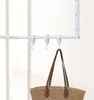 A white coat rack with hooks and a straw bag hanging from one hook. Náhled obrázku produktu