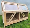 A wooden hamster cage with clear plastic windows sits on green grass. Produktbild-Vorschau
