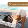 A person is relaxing on a lounge chair by a pool, reading a book. Produktbild-Vorschau