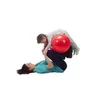 A woman and a child are on the floor with a red exercise ball between them. Produktbild-Vorschau