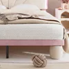A close-up view of a bed with a pink frame and a beige headboard. Náhled obrázku produktu