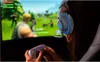 A person wearing gaming headphones and holding a game controller, playing a video game on a large screen. Produktbild-Vorschau