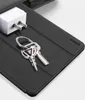 A close-up shot of a black case with keys and a white power adapter on it. Náhľad obrázku produktu
