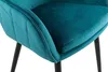 Close-up view of a teal velvet chair with diamond quilting and black legs. Produktbild-Vorschau