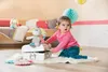 A baby playing with a stuffed animal in a nursery. Podgląd zdjęcia produktu