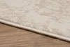 A close-up view of the edge of a rug on a wooden floor. Produktbild-Vorschau