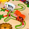 A close-up view of a wooden activity table for children, featuring colorful animal figures and jungle-themed decorations. Podgląd zdjęcia produktu